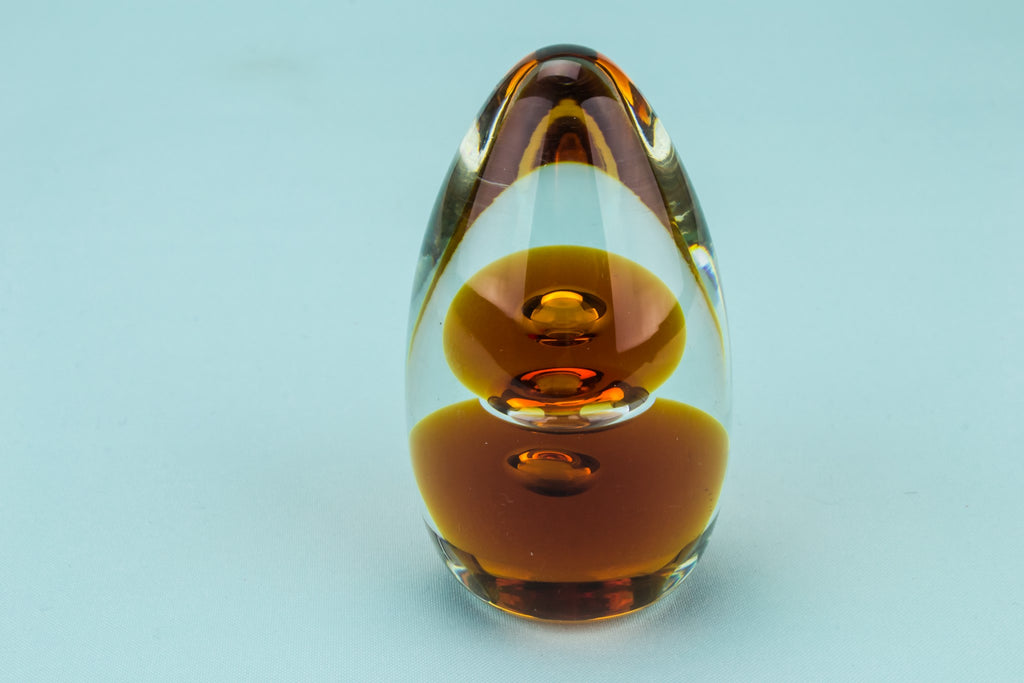 Amber glass egg paperweight