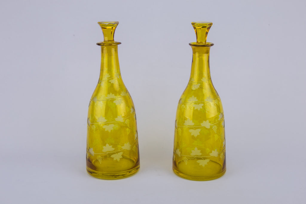 2 yellow glass wine bottles