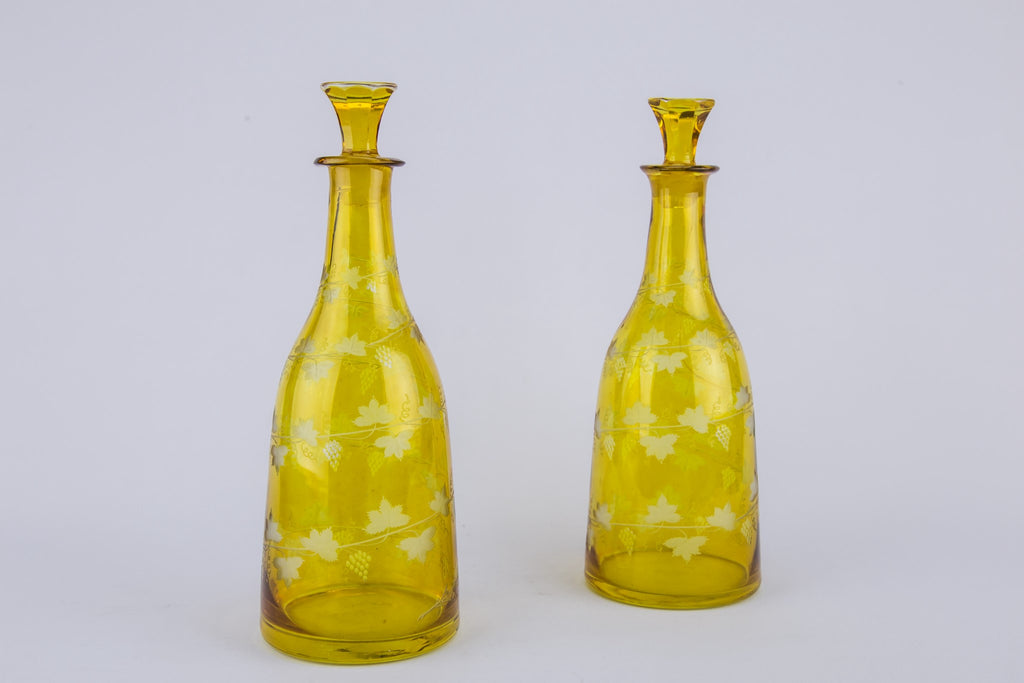 2 yellow glass wine bottles