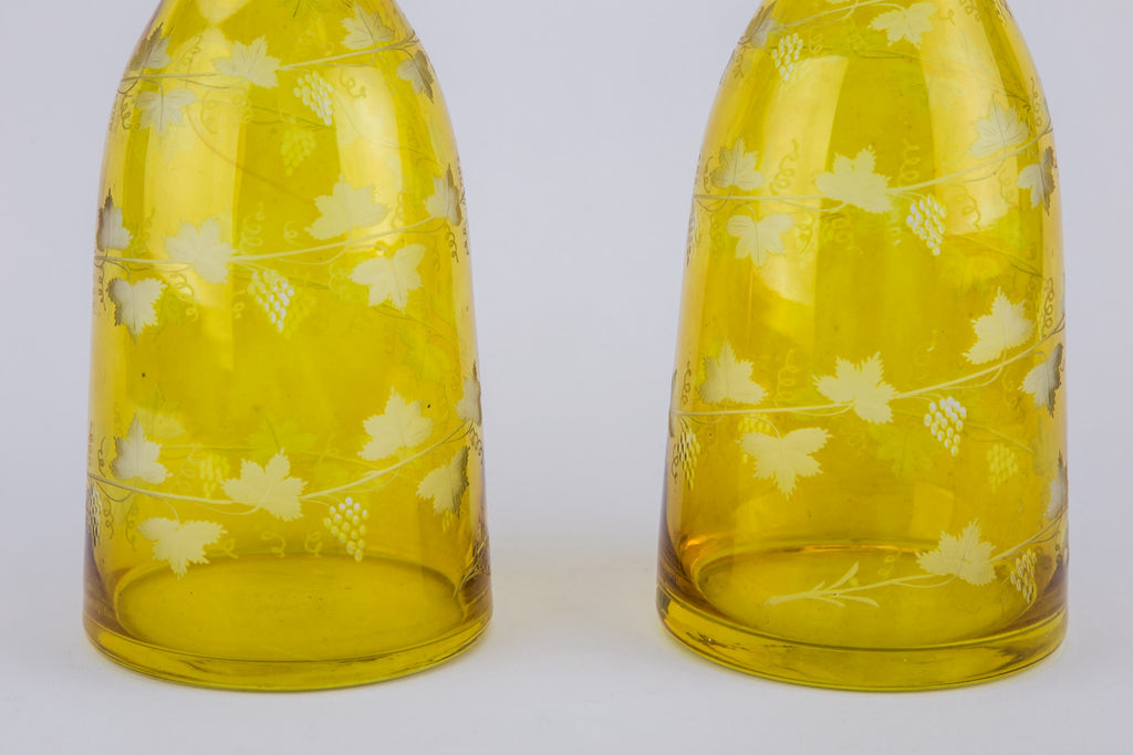2 yellow glass wine bottles