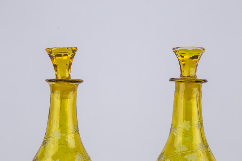 2 yellow glass wine bottles