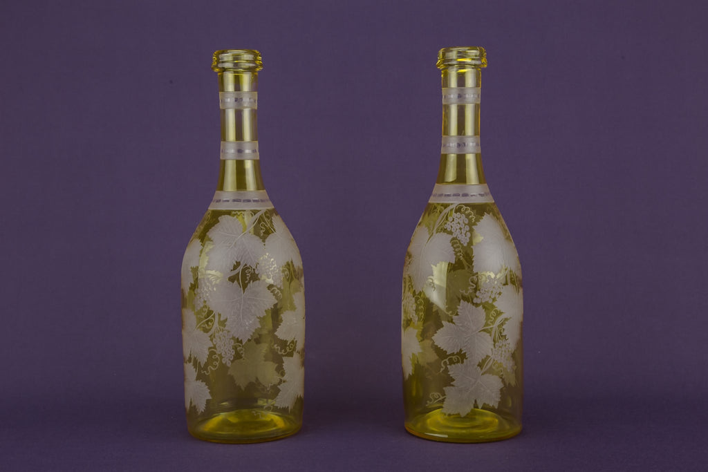 2 yellow glass wine bottles