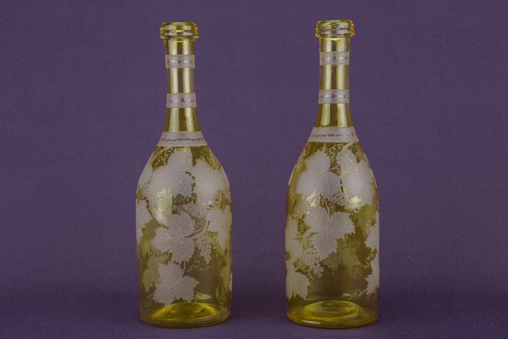 2 yellow glass wine bottles