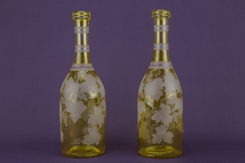 2 yellow glass wine bottles