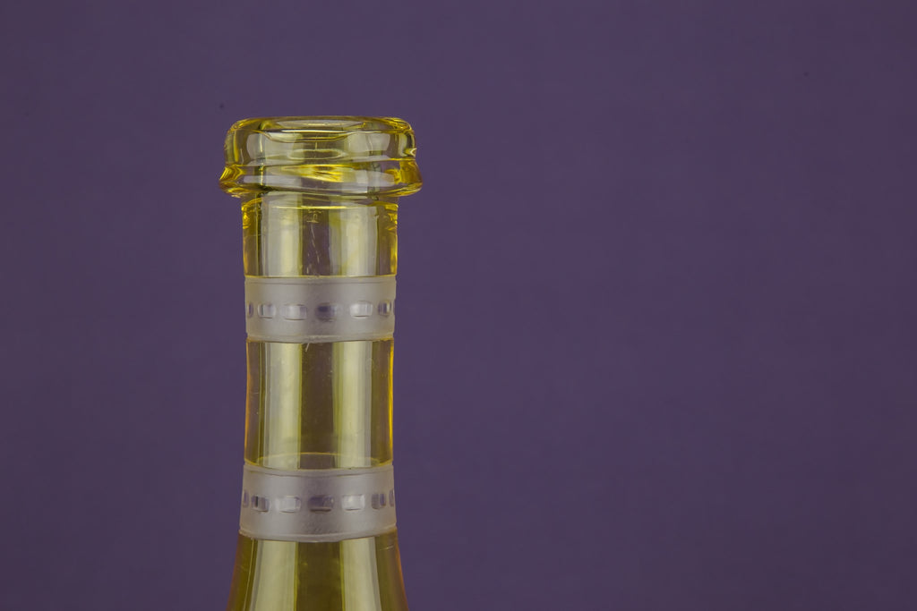 2 yellow glass wine bottles