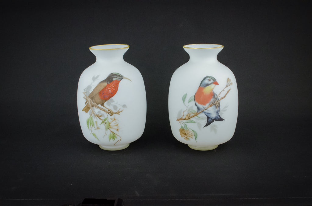 2 white glass vases