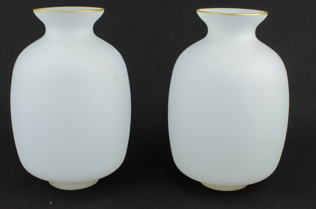 2 white glass vases