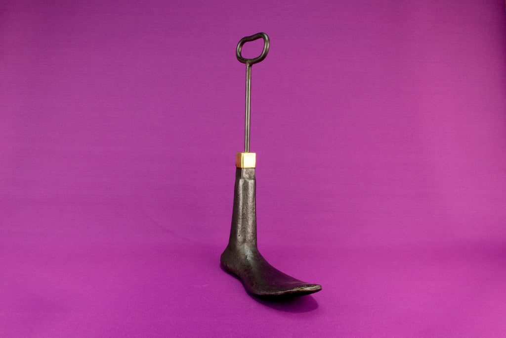 Boot shaped iron door stopper with a handle