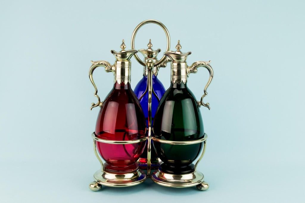 Three Colourful Decanters Set on a Stand, English 19th Century
