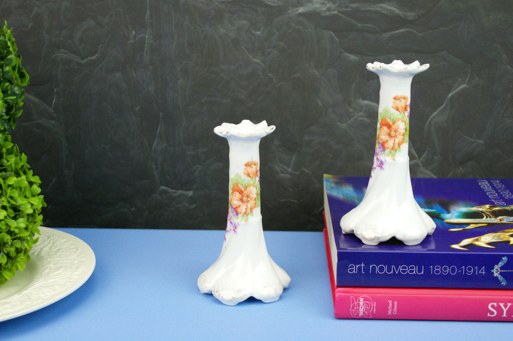2 white floral candlesticks