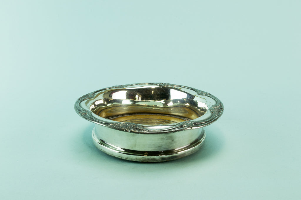 Silver plated bottle coaster, circa 1910